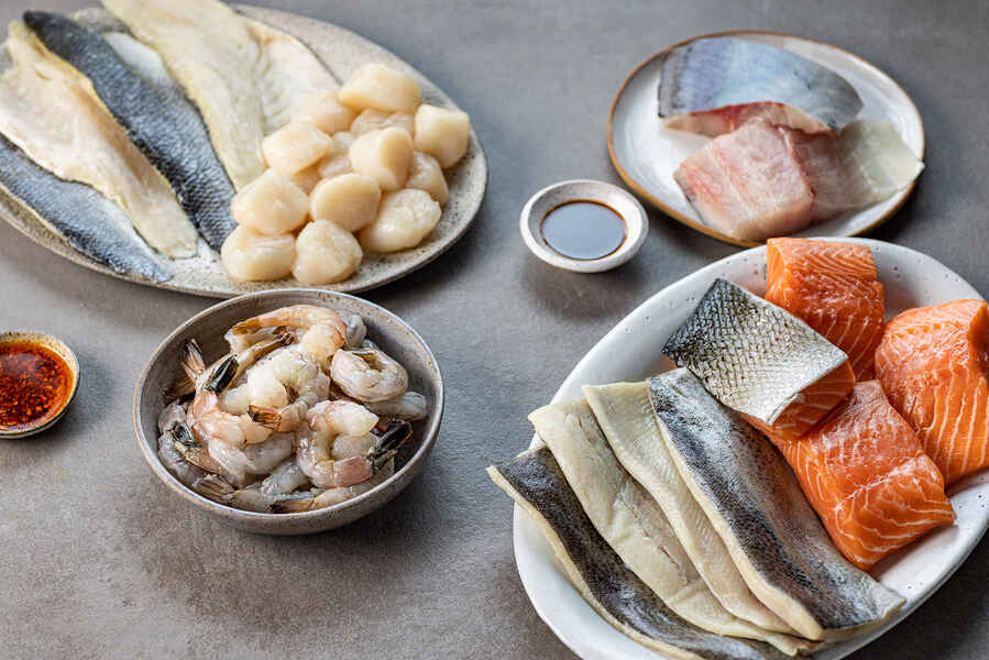 Assortment of plated raw KnowSeafood seafood.