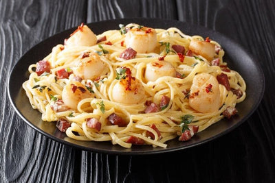 bowl of pasta with cooked bay scallops