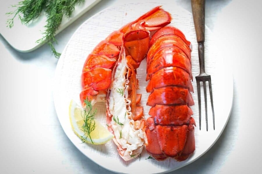 cooked lobster tails on white plate