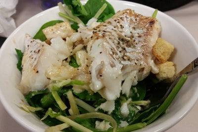 wild icelandic cod salad over spinach and croutons