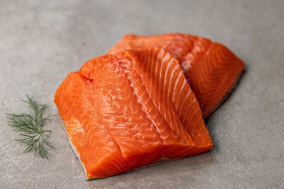 two raw wild alaska coho salmon portions