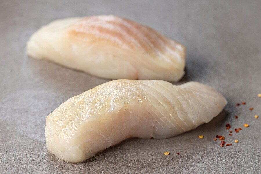 two raw wild alaska halibut portions