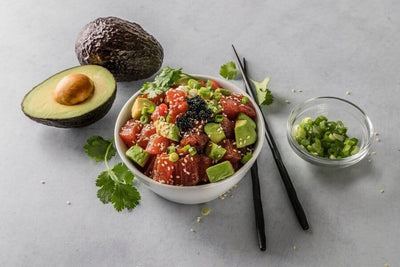 bowl of tuna poke with avocado and scallions