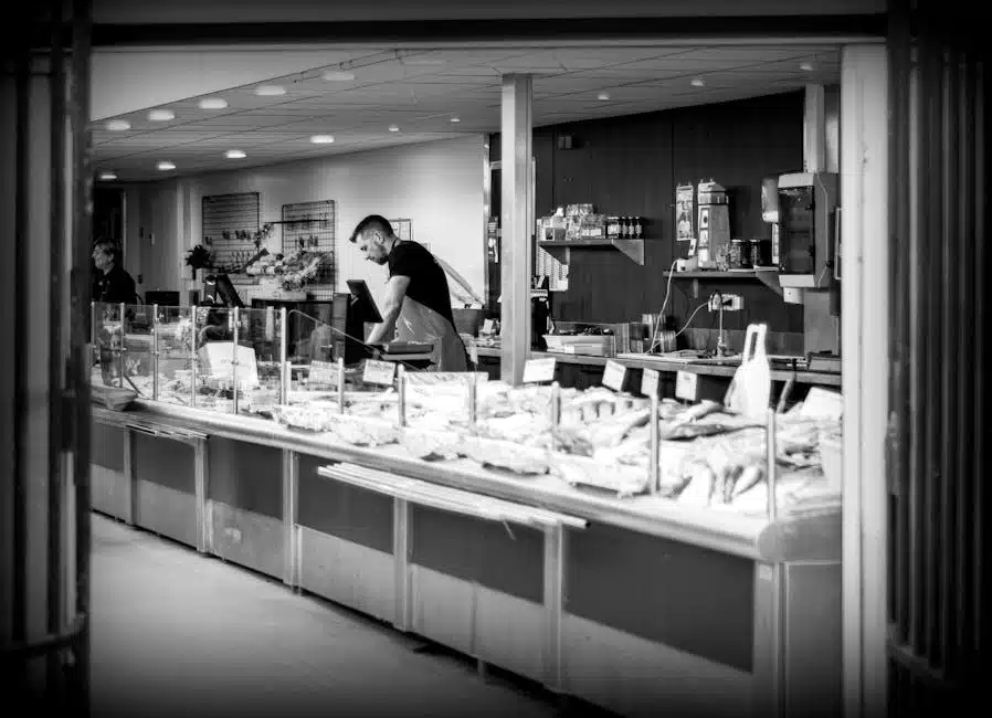 A refrigerated seafood display case at a market counter