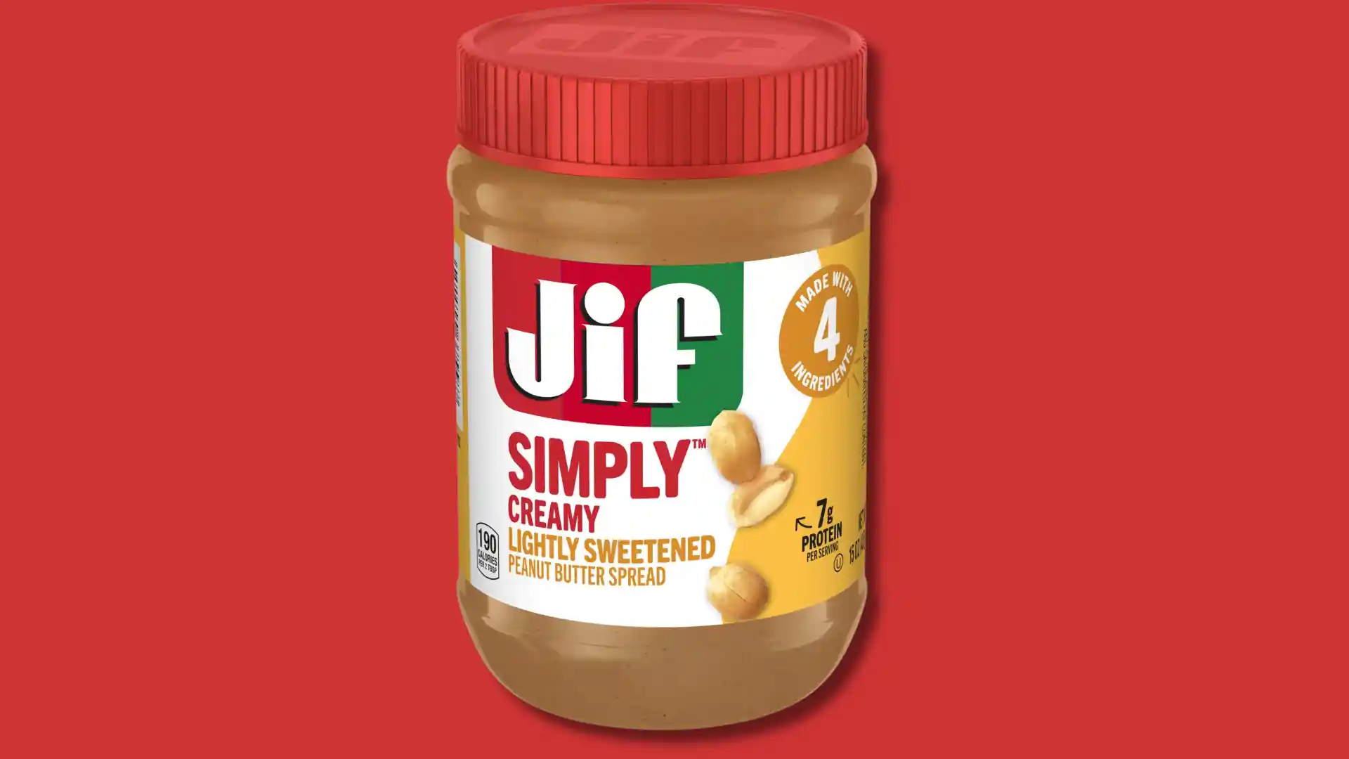 Jif Simply Creamy lightly sweetened peanut butter spread in a jar with a red lid.