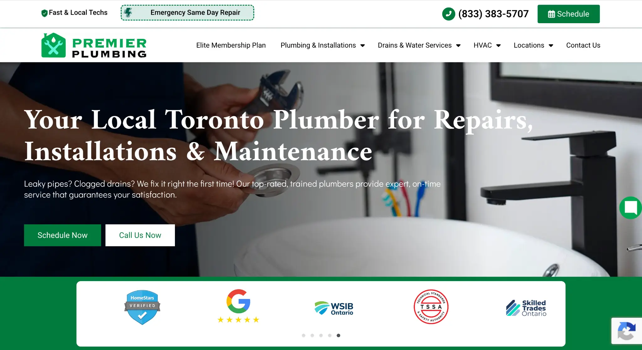 Plumber holding a wrench near a modern bathroom sink with sleek black faucet