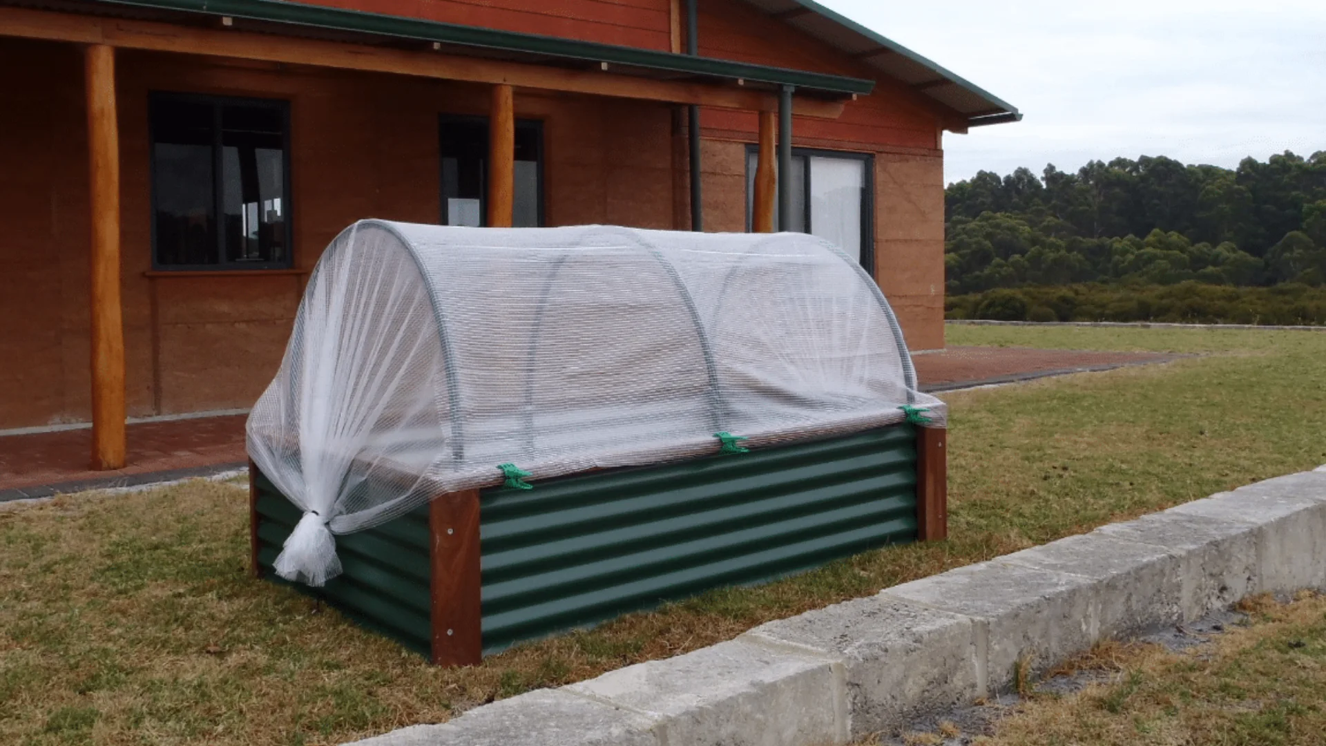 Protective cover placed over a raised garden bed to shield plants from cold temperatures and frost